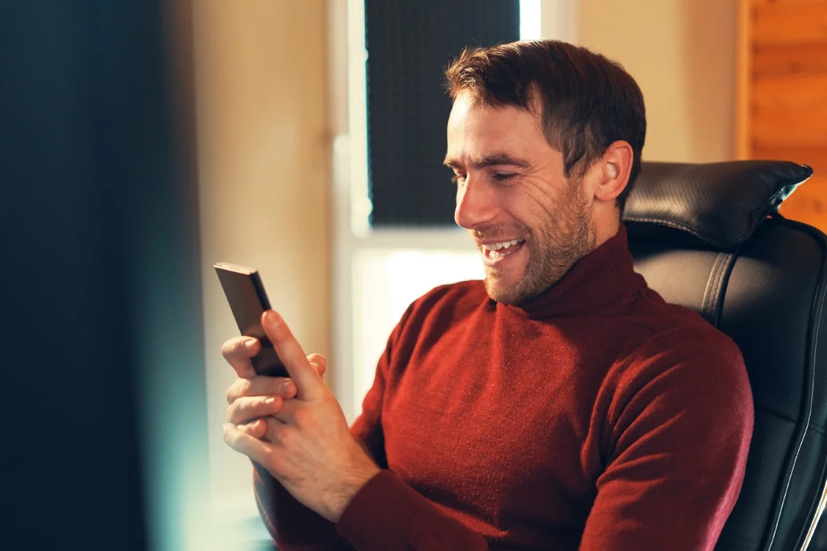 a man happy to receive good news while looking at BFDRMU6